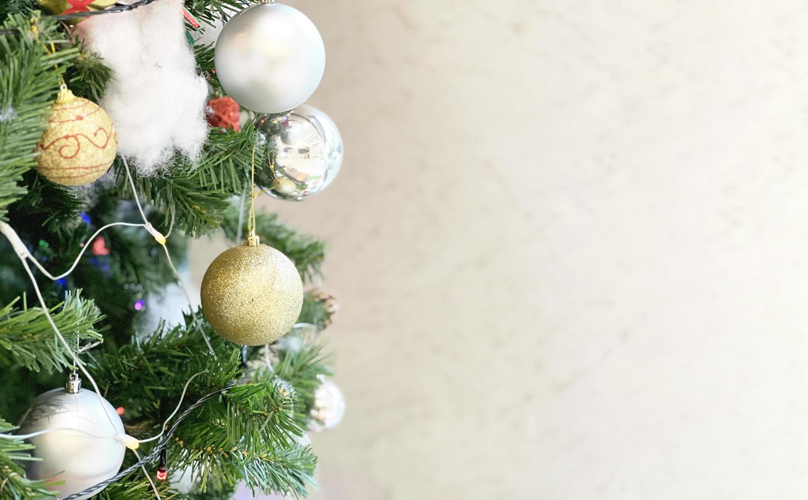 geschmückter Weihnachtsbaum mit bunten Geschenkbox und Glocke isoliert auf weißem Hintergrund foto