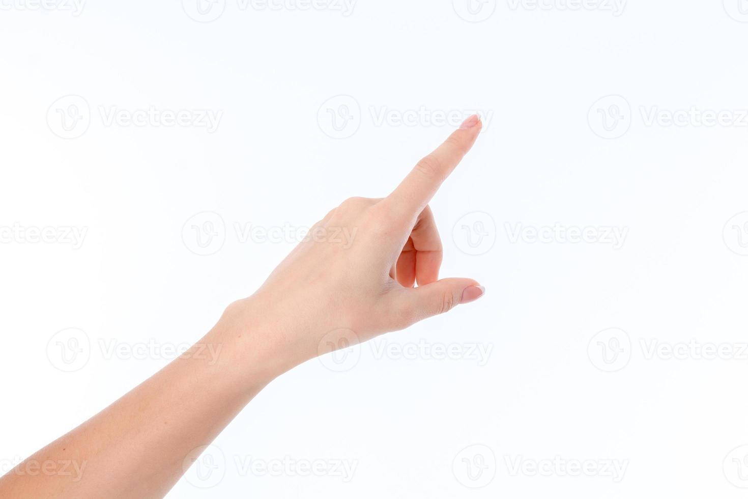 weibliche Hand zur Seite ausgestreckt und Zeigefinger isoliert auf weißem Hintergrund foto