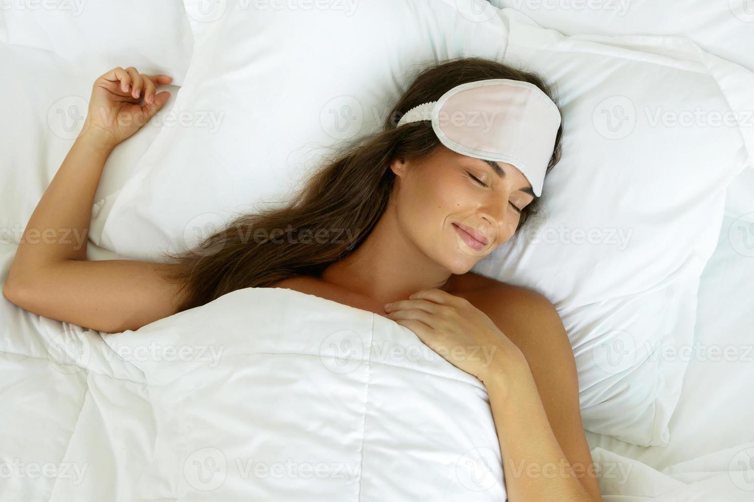 glückliche Frau, die nach gutem Schlaf aufwacht foto