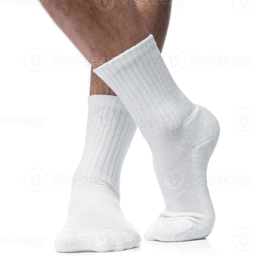 männliche Füße mit weißen Baumwollsocken auf weißem Hintergrund foto