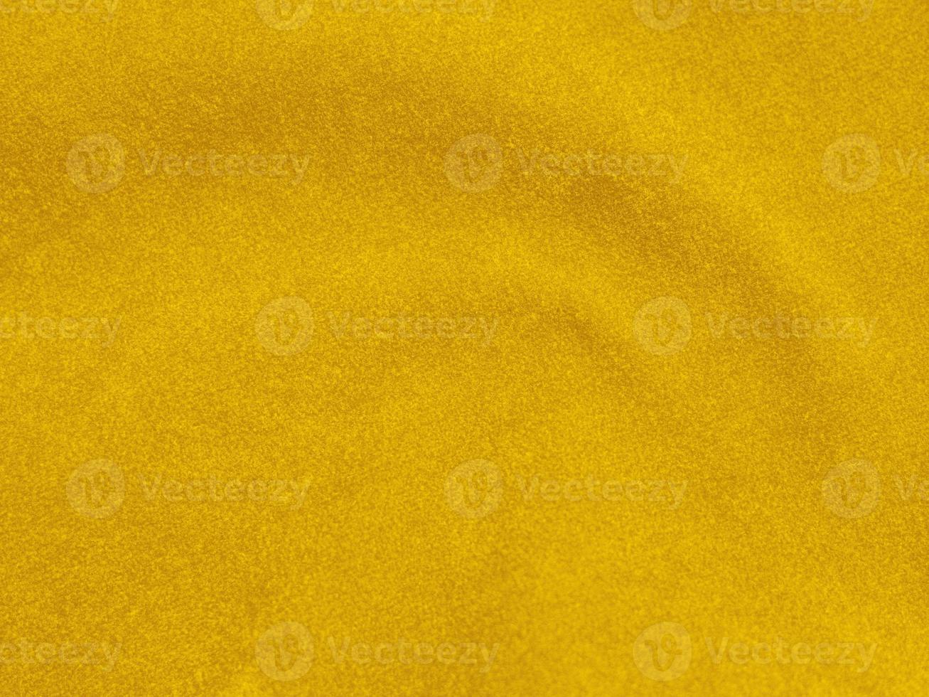 gelbe Samtstoffstruktur als Hintergrund verwendet. leerer gelber Stoffhintergrund aus weichem und glattem Textilmaterial. Es gibt Platz für Text foto