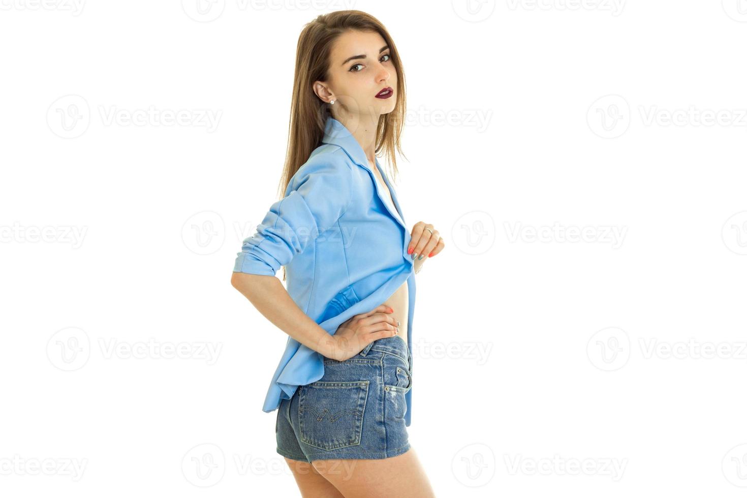 schlanke schöne dame in shorts und blauer jacke schaut in die kamera und posiert foto