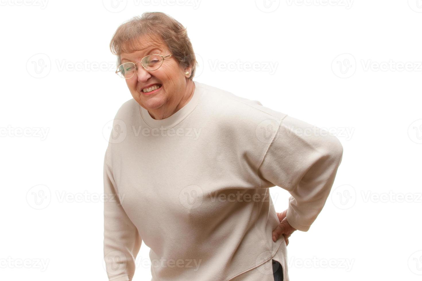 Seniorin mit Rückenschmerzen foto