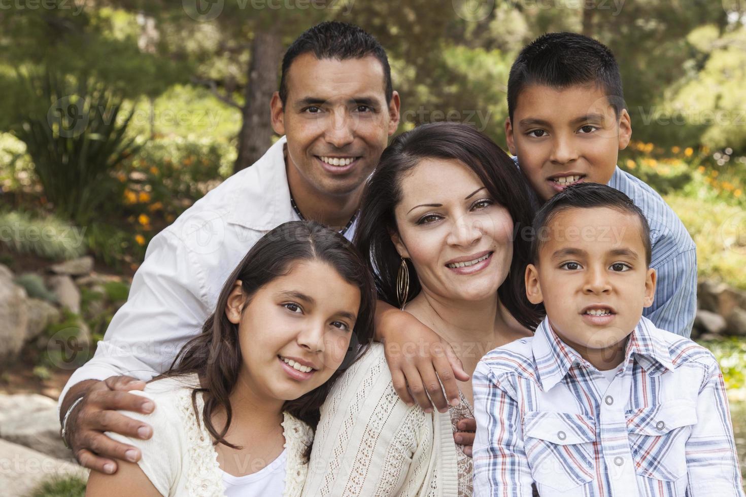 glückliches attraktives hispanisches Familienporträt im Park foto