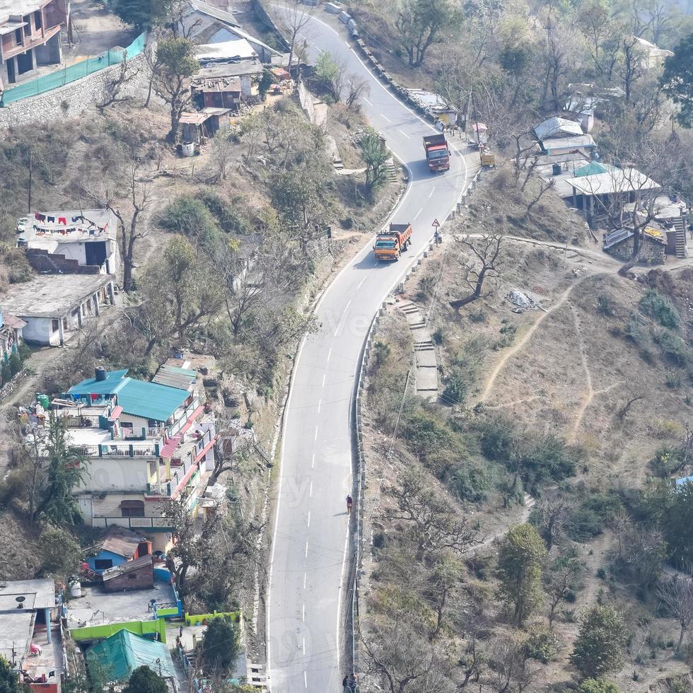 luftaufnahme von verkehrsfahrzeugen, die auf bergstraßen in nainital, uttarakhand, indien, fahren, blick von der oberseite des berges für die bewegung von verkehrsfahrzeugen foto