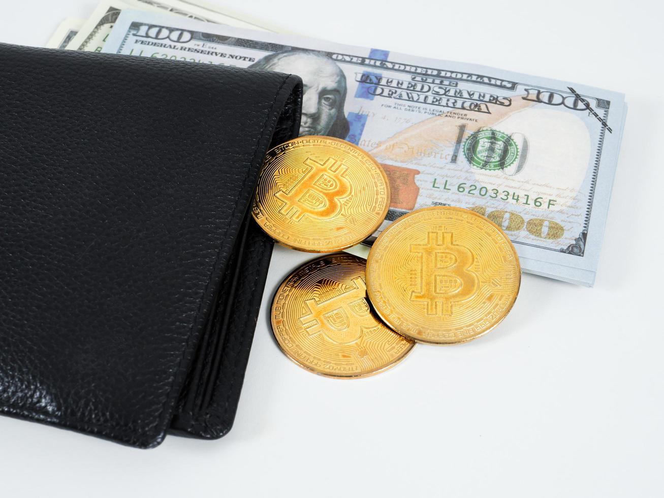 goldene bitcoins am weißen hintergrund der brieftasche und des dollargeldes foto