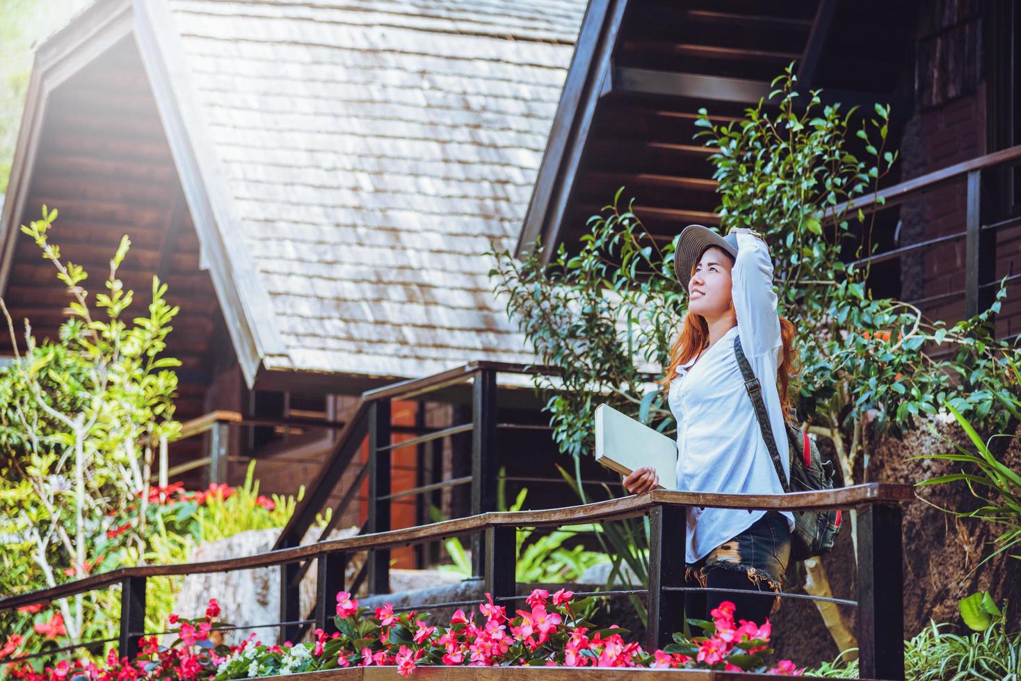 asiatische frau reisen natur. Reisen entspannen. stehendes Lesebuch den Balkon des Hauses. im Sommer. foto