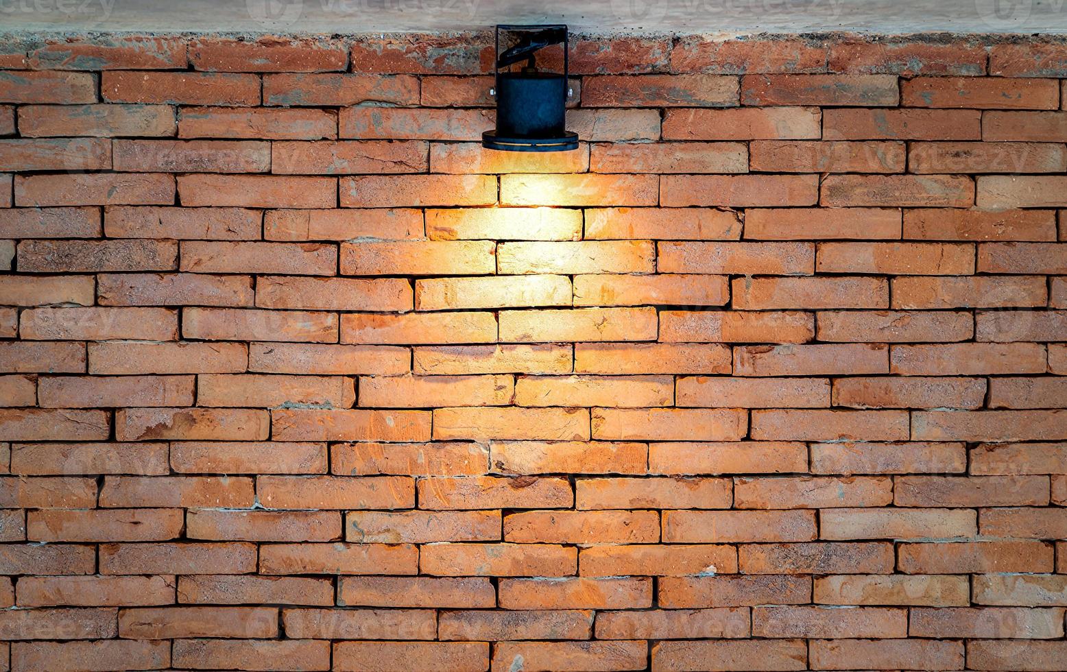 Brickwall-Hintergrund mit den Wolframlichtern von Spotlight für Kunstausstellungen oder klassischen Vintage-Display-Produkthintergrund. foto