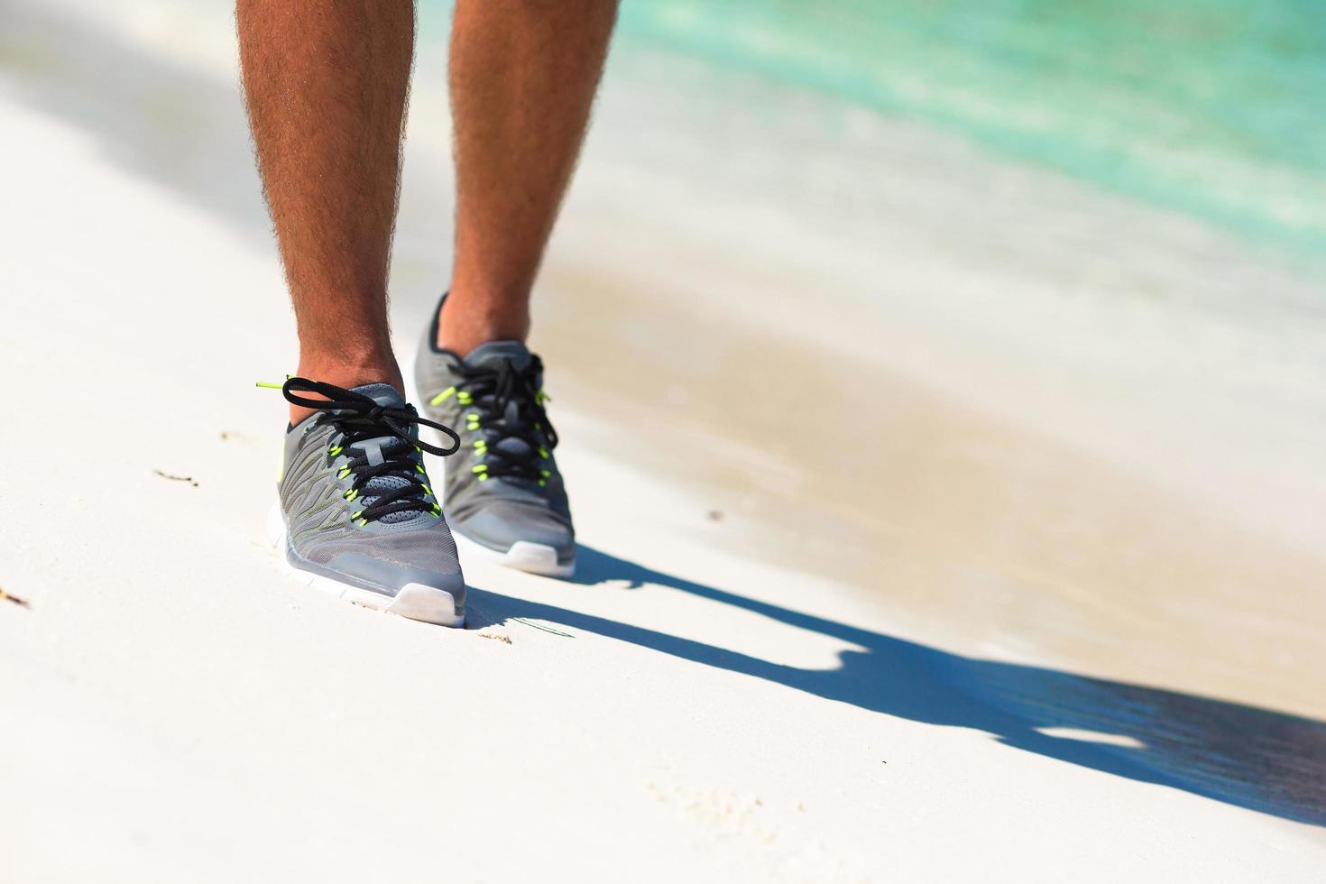 Nahaufnahme der Schuhe eines Läufers am Strand foto