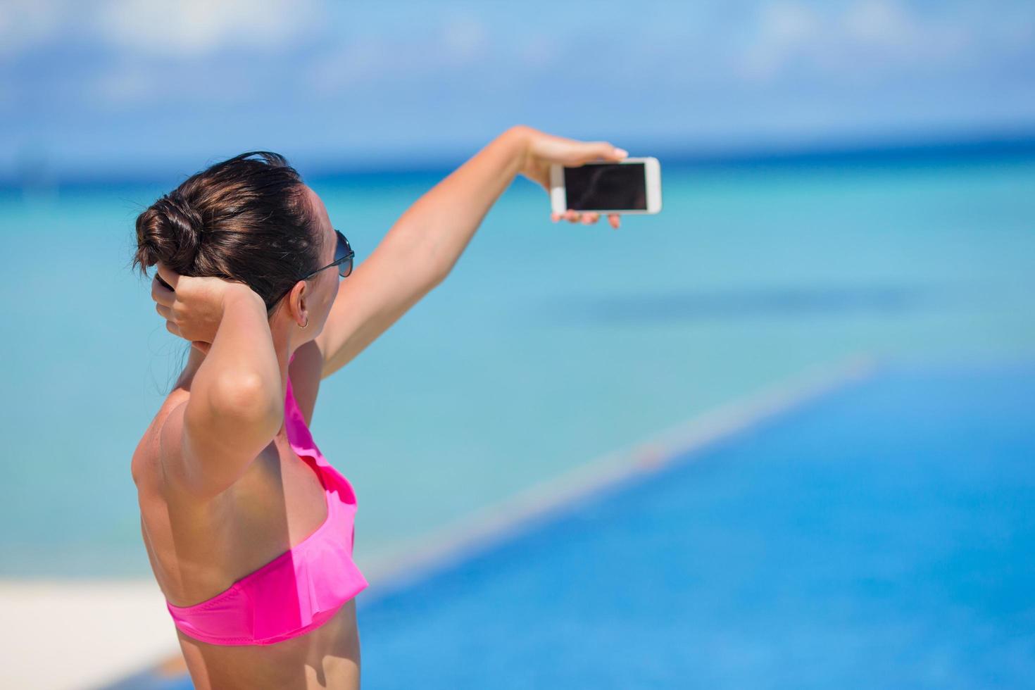 Frau macht ein Selfie mit einem Telefon foto