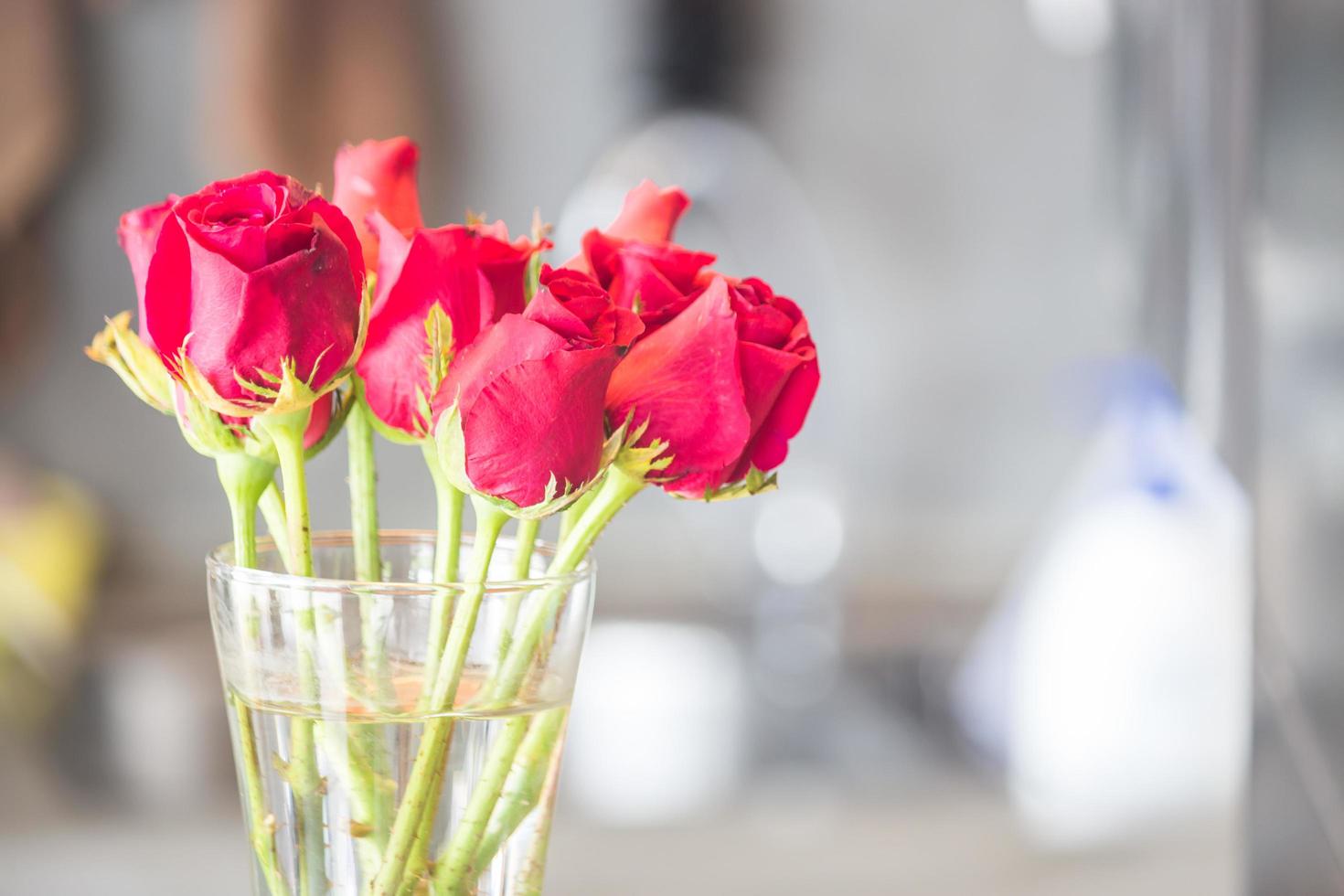 Strauß blühender roter Rosen in Vase foto