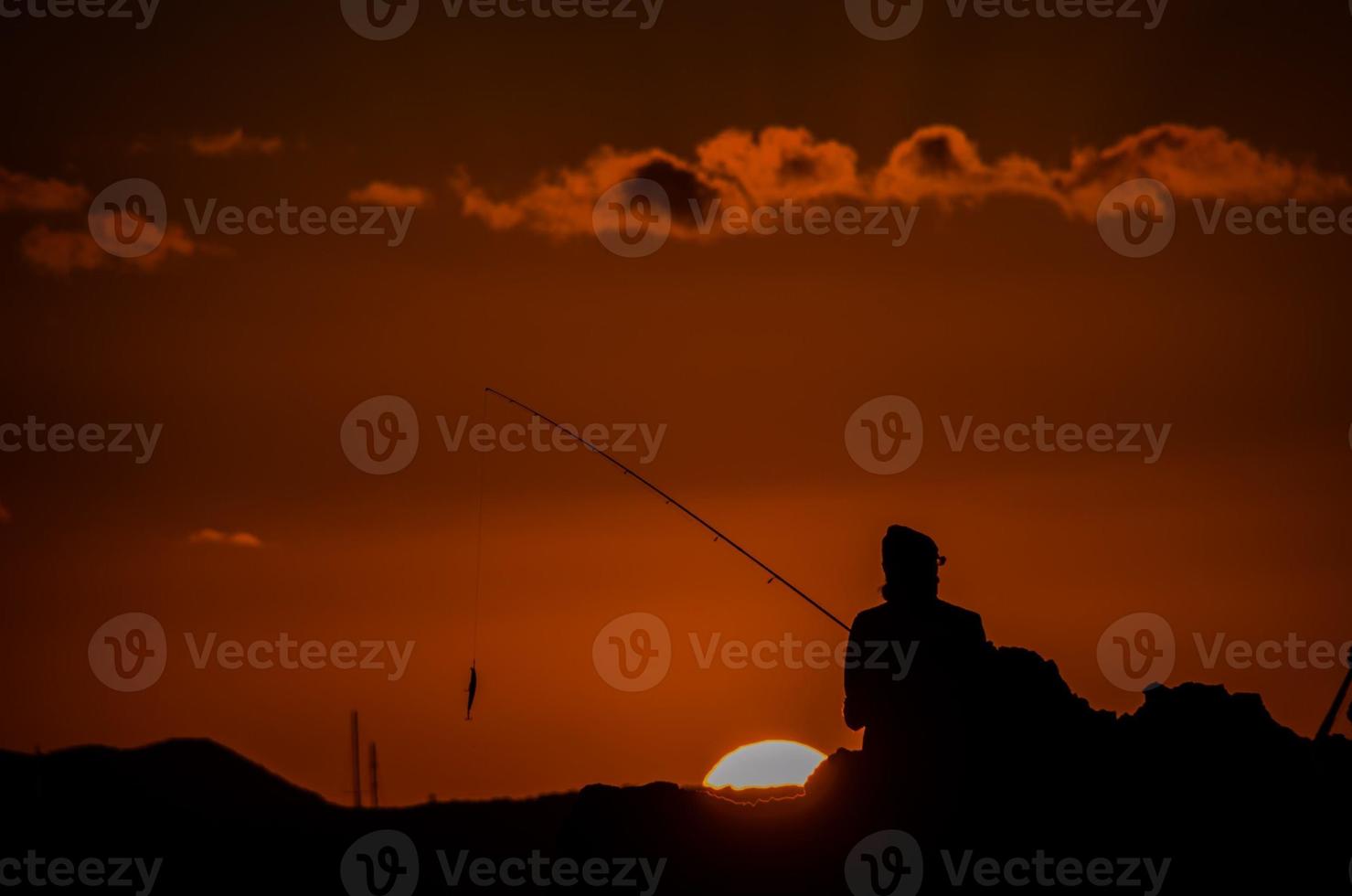 Fischer über dem Sonnenuntergang foto