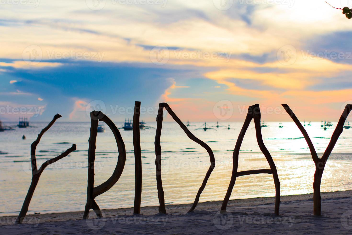 perfekter weißer sandstrand auf tropischer insel mit holzbuchstaben silhouette gemacht freitag wort foto