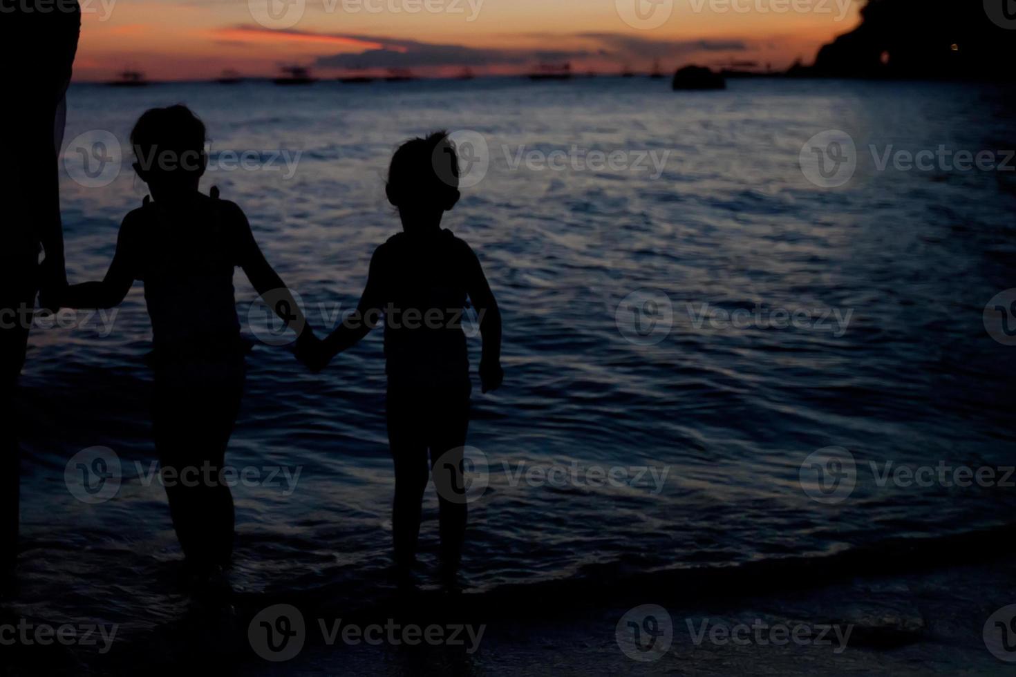 Familie von drei Silhouette im Sonnenuntergang am Strand von Boracay foto