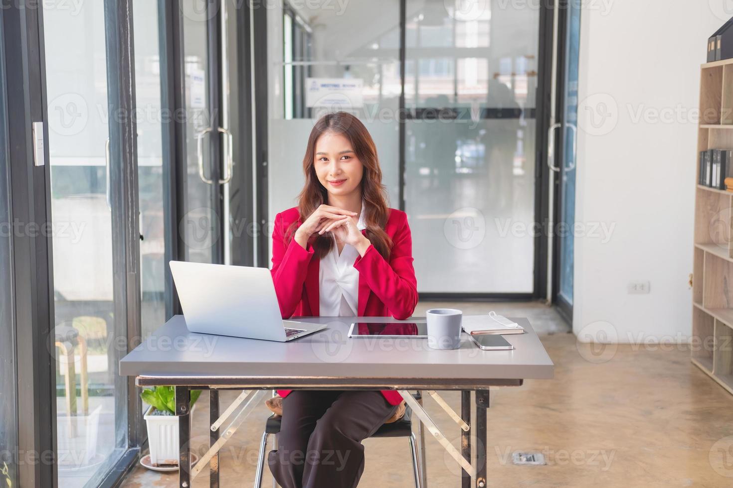 marketing, finanzen, buchhaltung, planung, geschäftsfrauen analysieren unternehmensergebnisse und gewinne mit grafikstatistiken. Verwenden Sie einen Laptop-Computer und einen Taschenrechner, um den Saldo des Unternehmens zu berechnen. foto