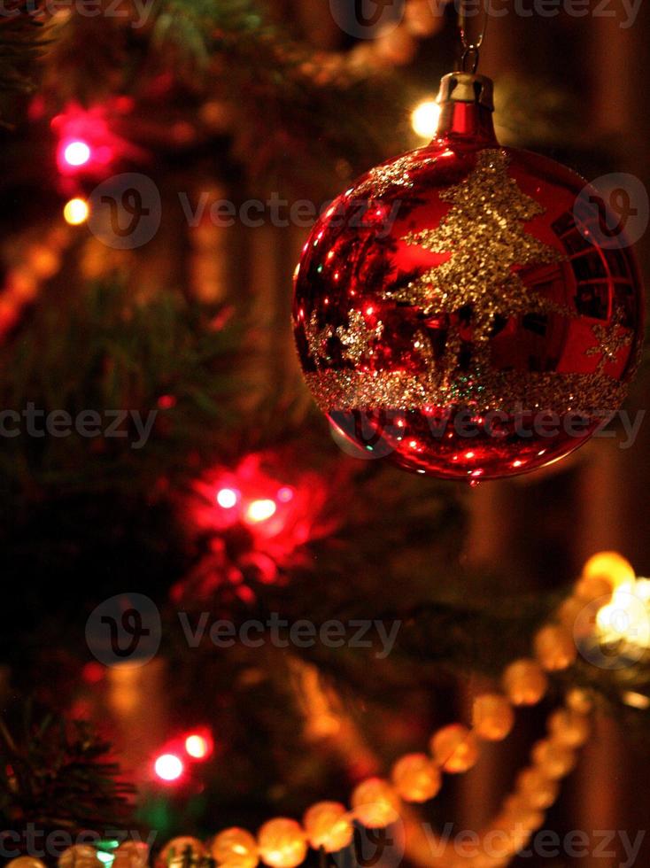 reflektierende rote Weihnachtskugelverzierung am Baum foto