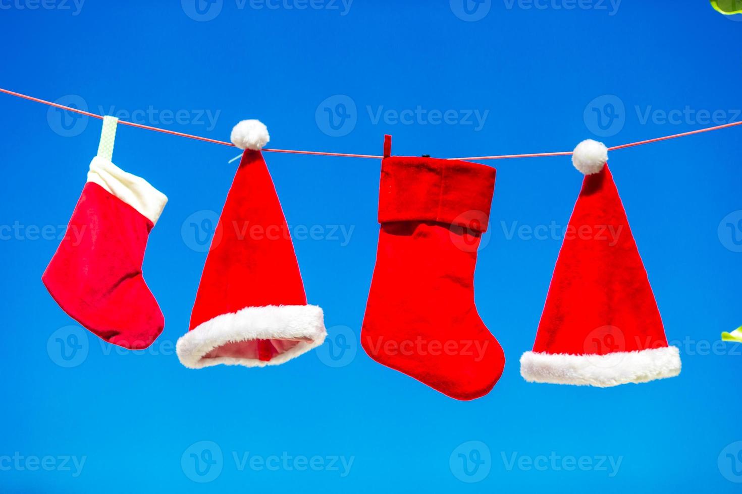 Weihnachtskonzept Sankt-Hüte und Strumpf Hintergrund blauer Himmel foto