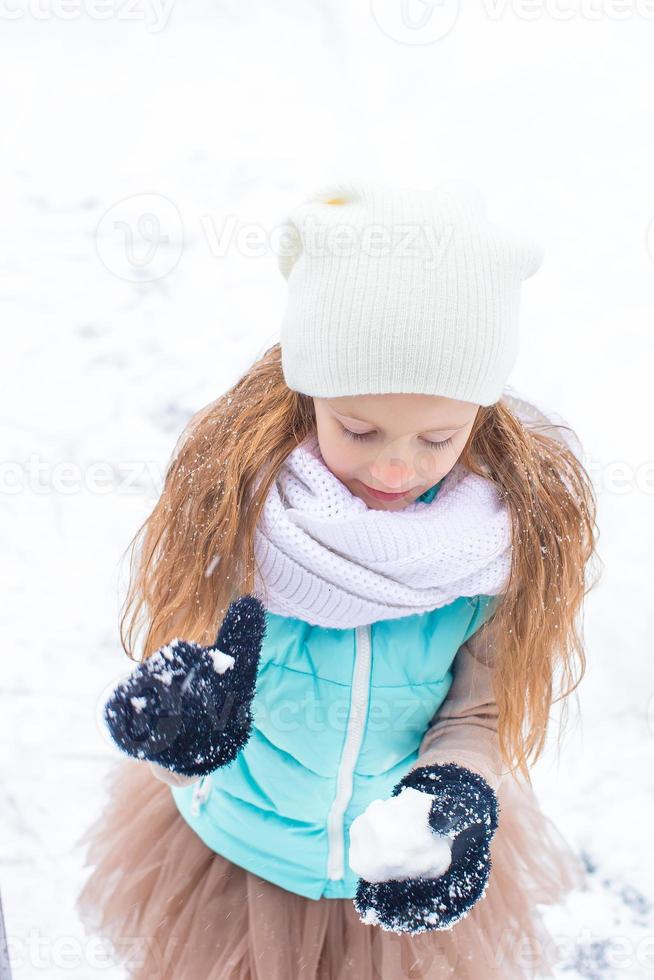 entzückendes kleines Mädchen am gefrorenen Wintertag im Freien foto