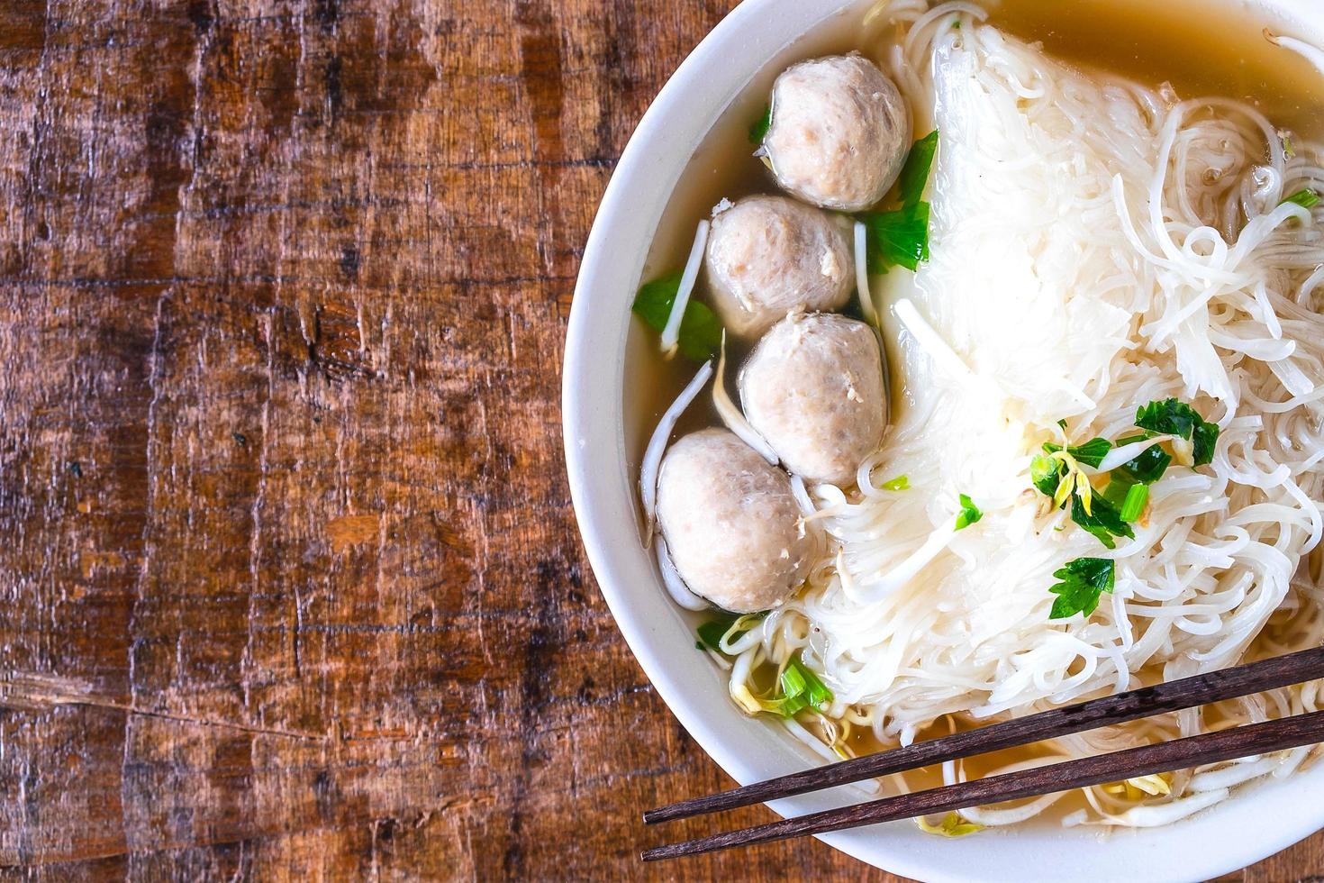 Draufsicht einer Schüssel Ramen auf einem Holztisch foto