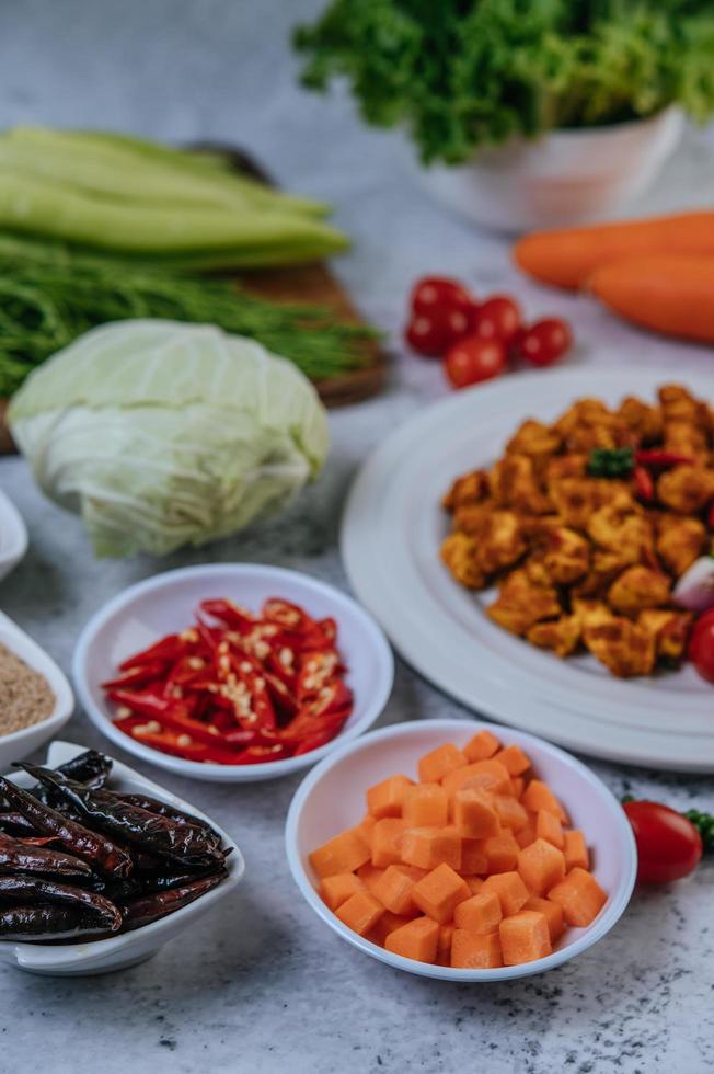 Karottenwürfel, getrocknete Chilis, gerösteter Reis, Chili und Kohl foto