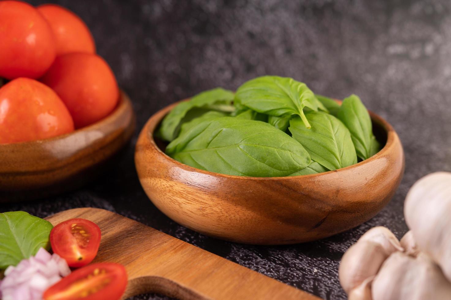 Thymian und Tomaten in einer Holzschale mit Knoblauch foto