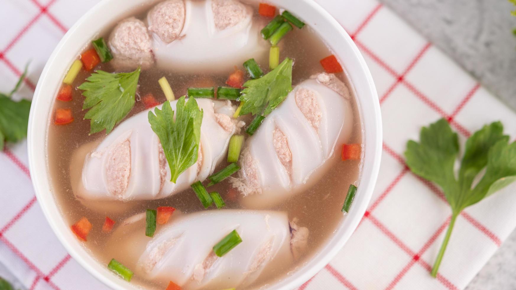 weiße Schüssel Tintenfischsuppe mit Schweinefleisch foto