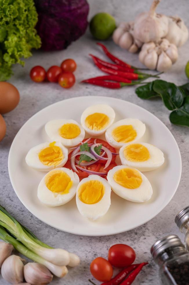 halb gekochte Eier mit Tomaten und Frühlingszwiebeln foto