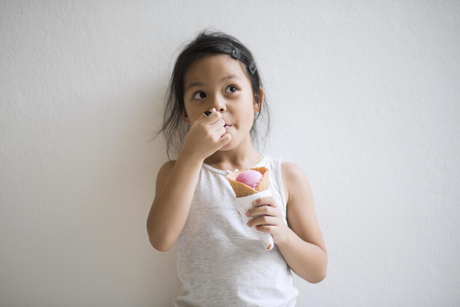 Porträt eines kleinen Mädchens, das Eis isst foto