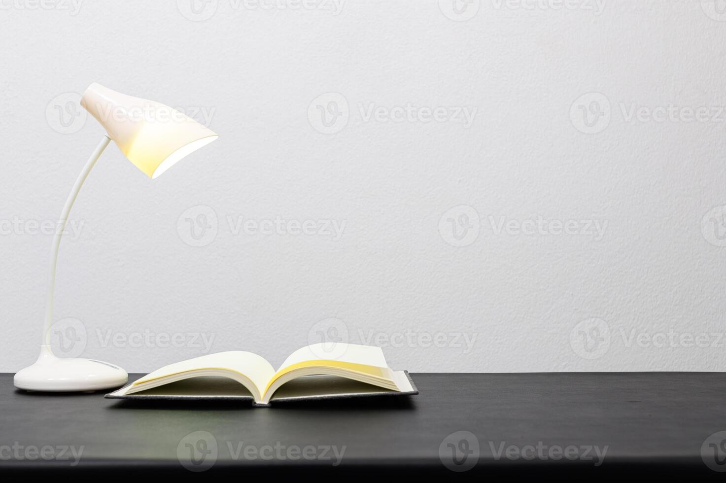 Buch und Lampe auf dem Tisch foto