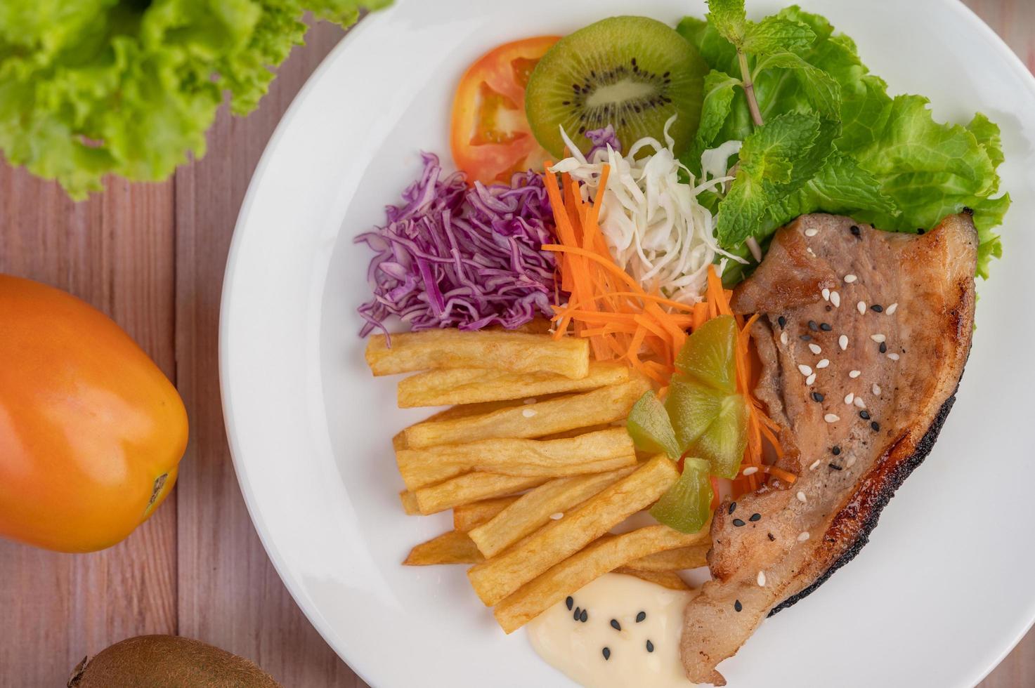 Fischsteak mit Pommes Frites und Salat foto