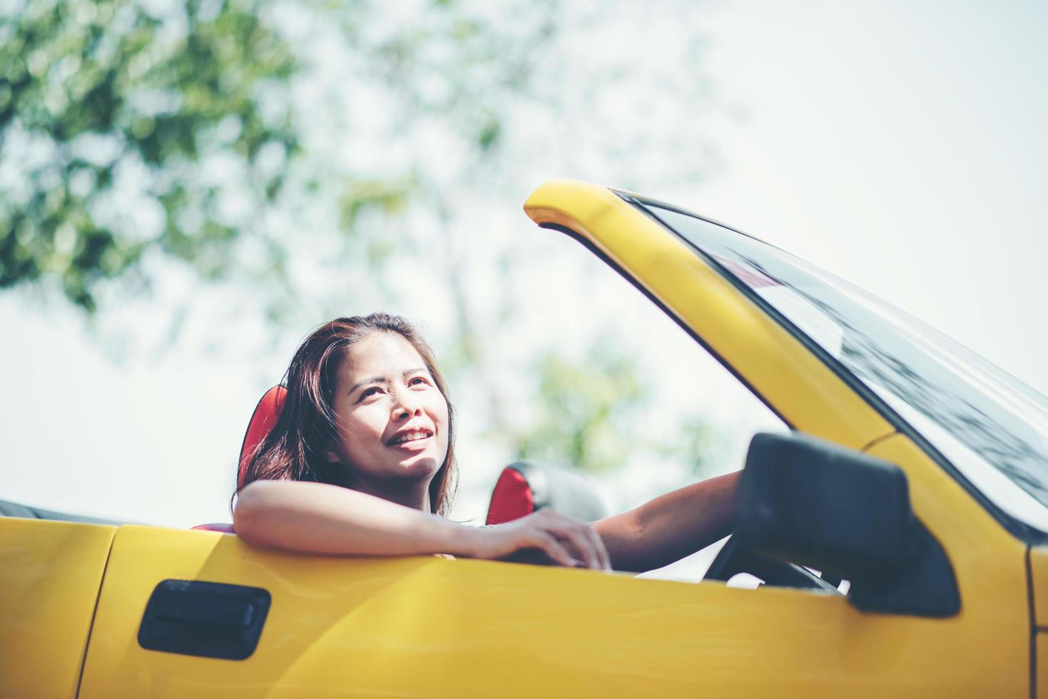 glückliche Frau, die das Verdeck unten im Cabrio genießt foto