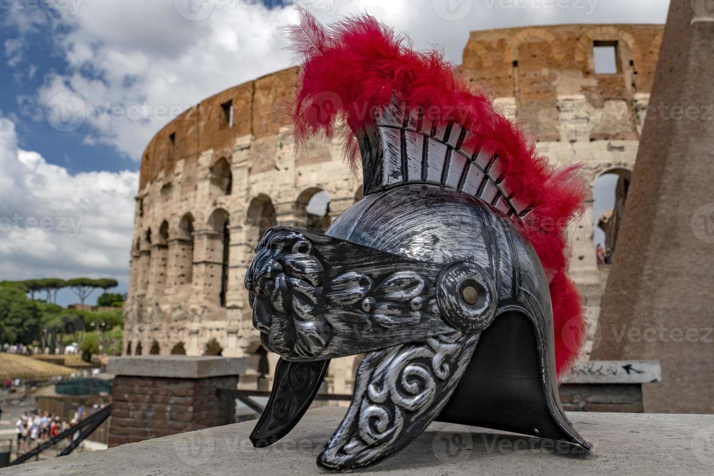 metallischer Gladiatorhelm auf Hintergrund des Kolosseums von Rom foto