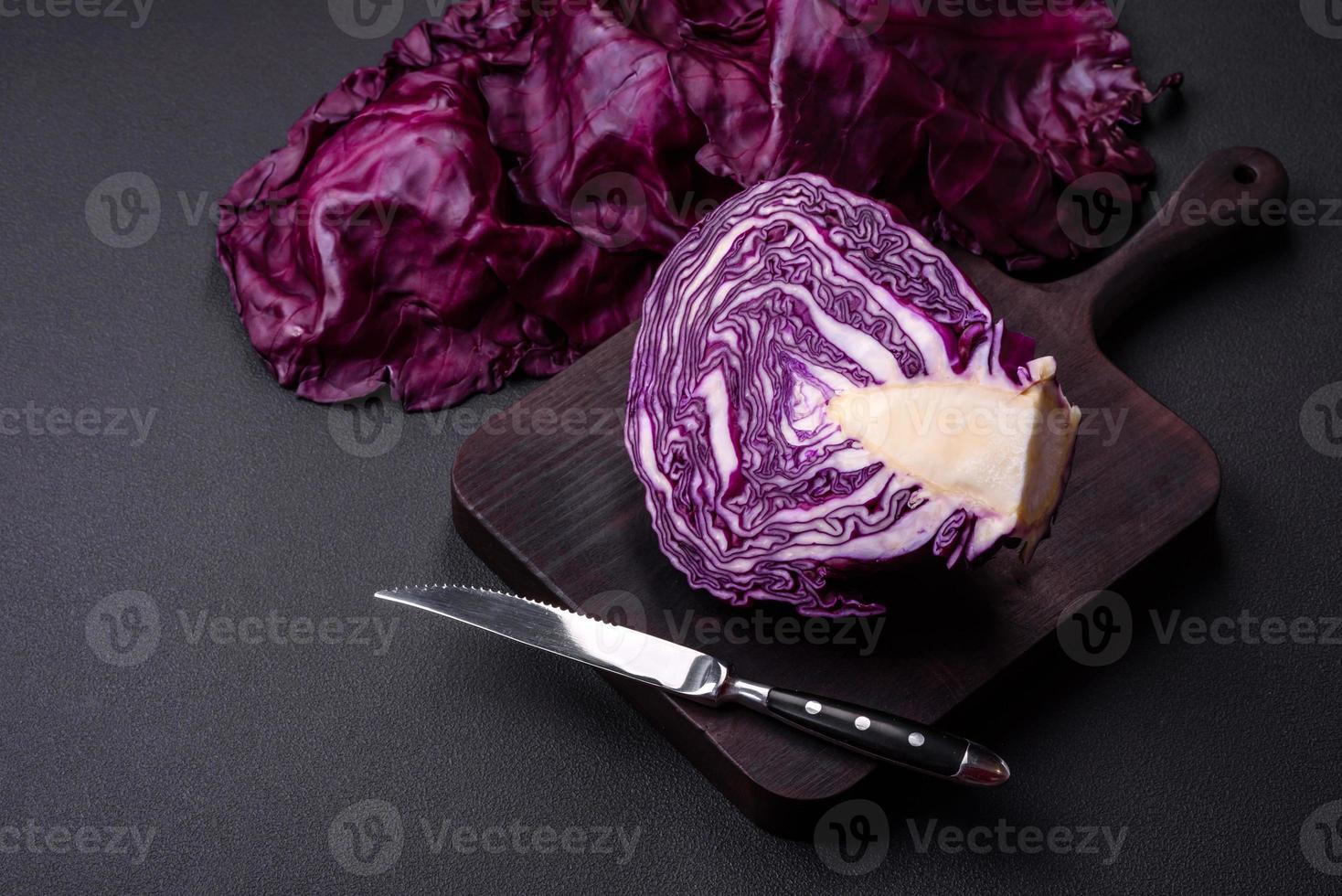 frischer schöner rotkohl mit strukturierten blättern auf einem dunklen betonhintergrund foto