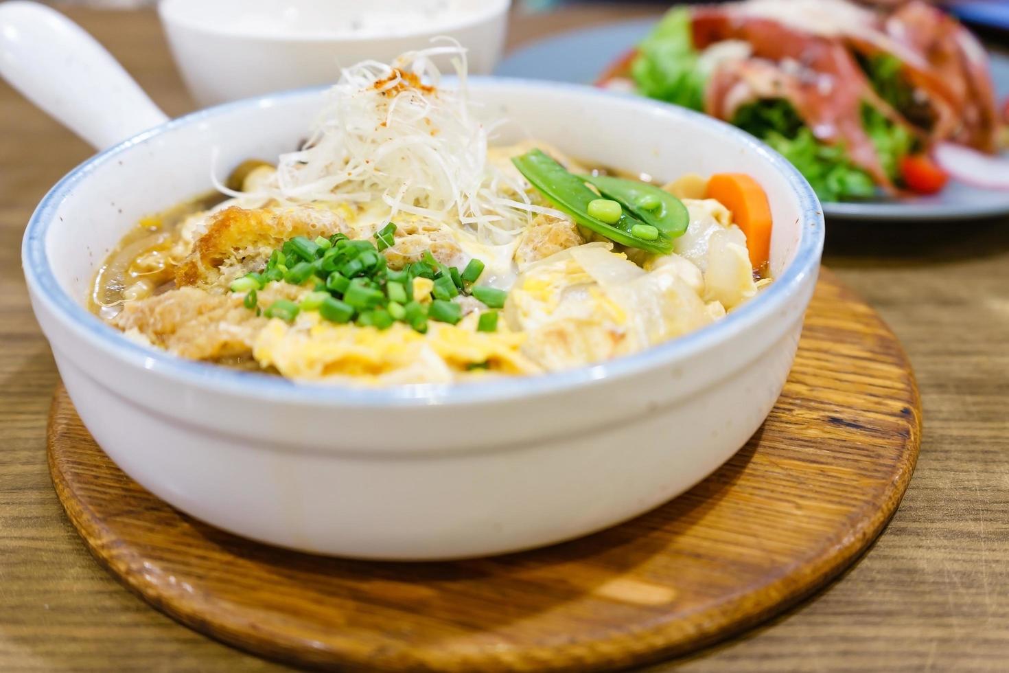 Gebratener Schweinebraten nach Katsudon- oder japanischer Art mit Ei und japanischer Zutat, gemischt auf Reis, bereit zum Servieren im Restaurant foto