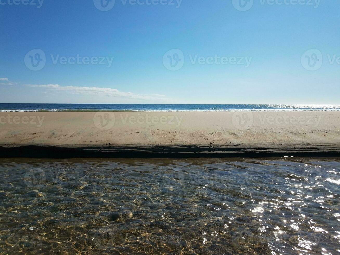 Wasser, das im Fluss am Strand in der Nähe des Ozeans fließt foto