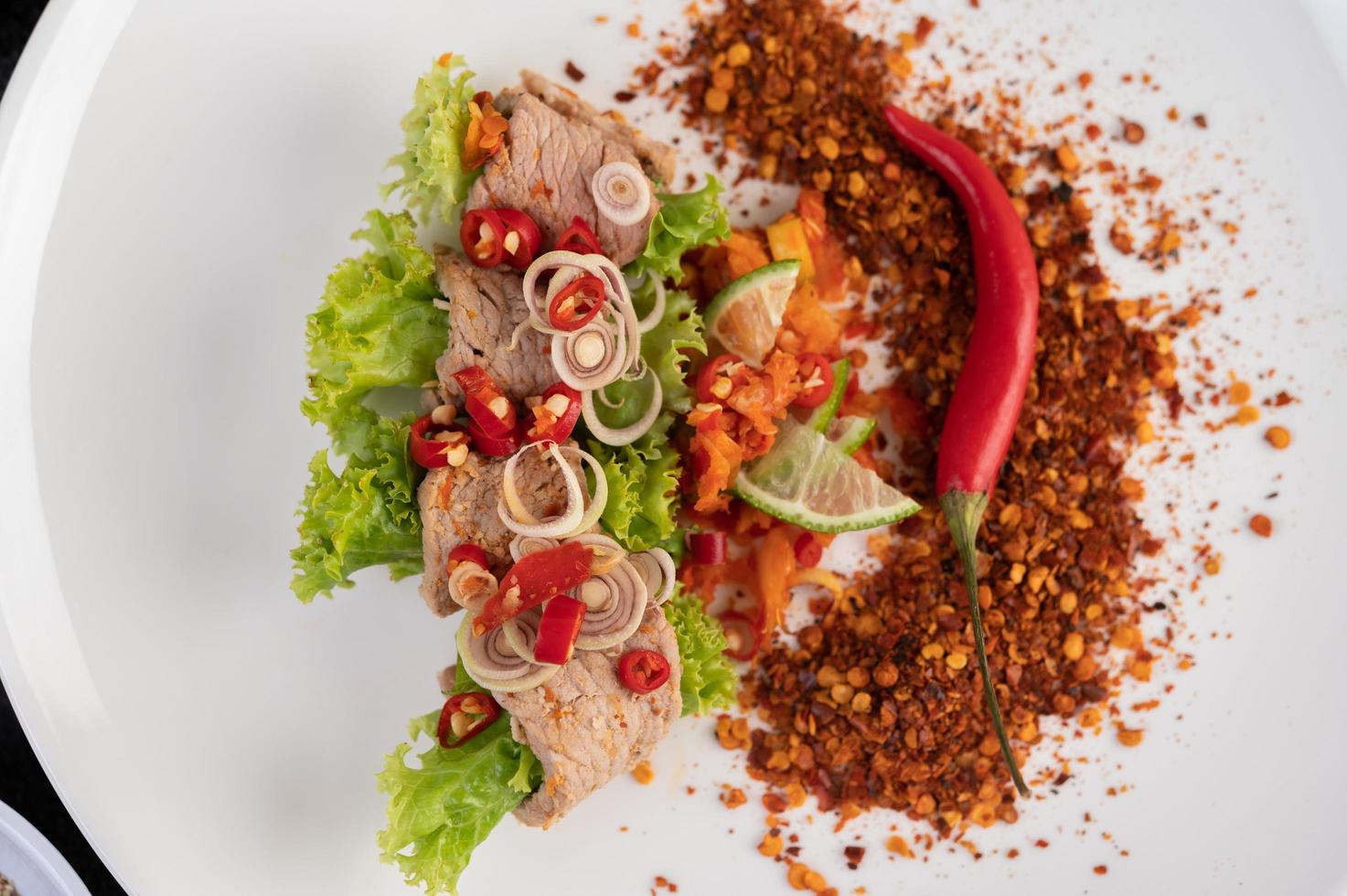 würziger Schweinefleischsalat mit Galangal, Zitrone, Chili und Knoblauch foto