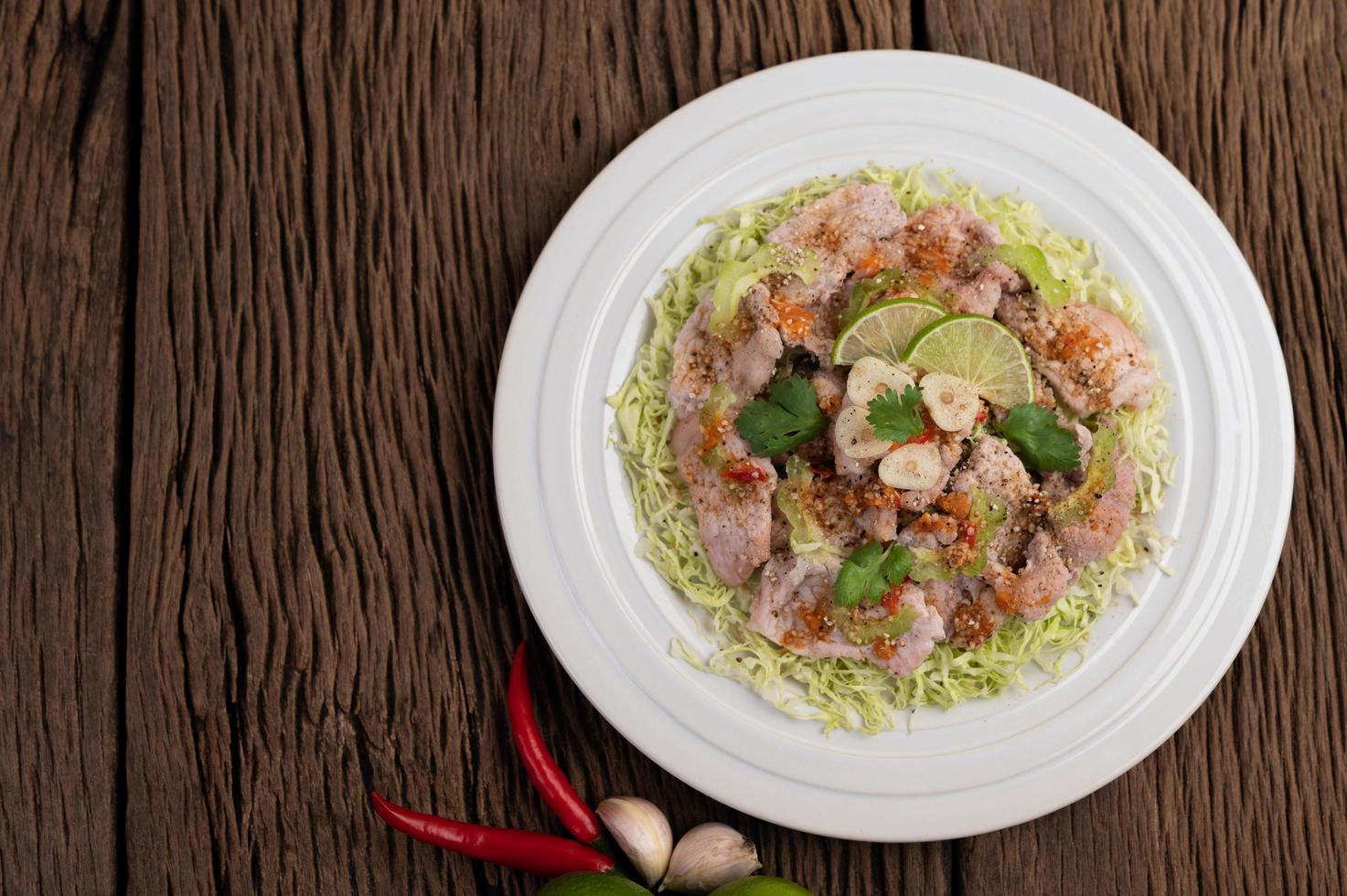 würziger Limettenschweinefleischsalat mit Galangal, Chili und Tomaten foto