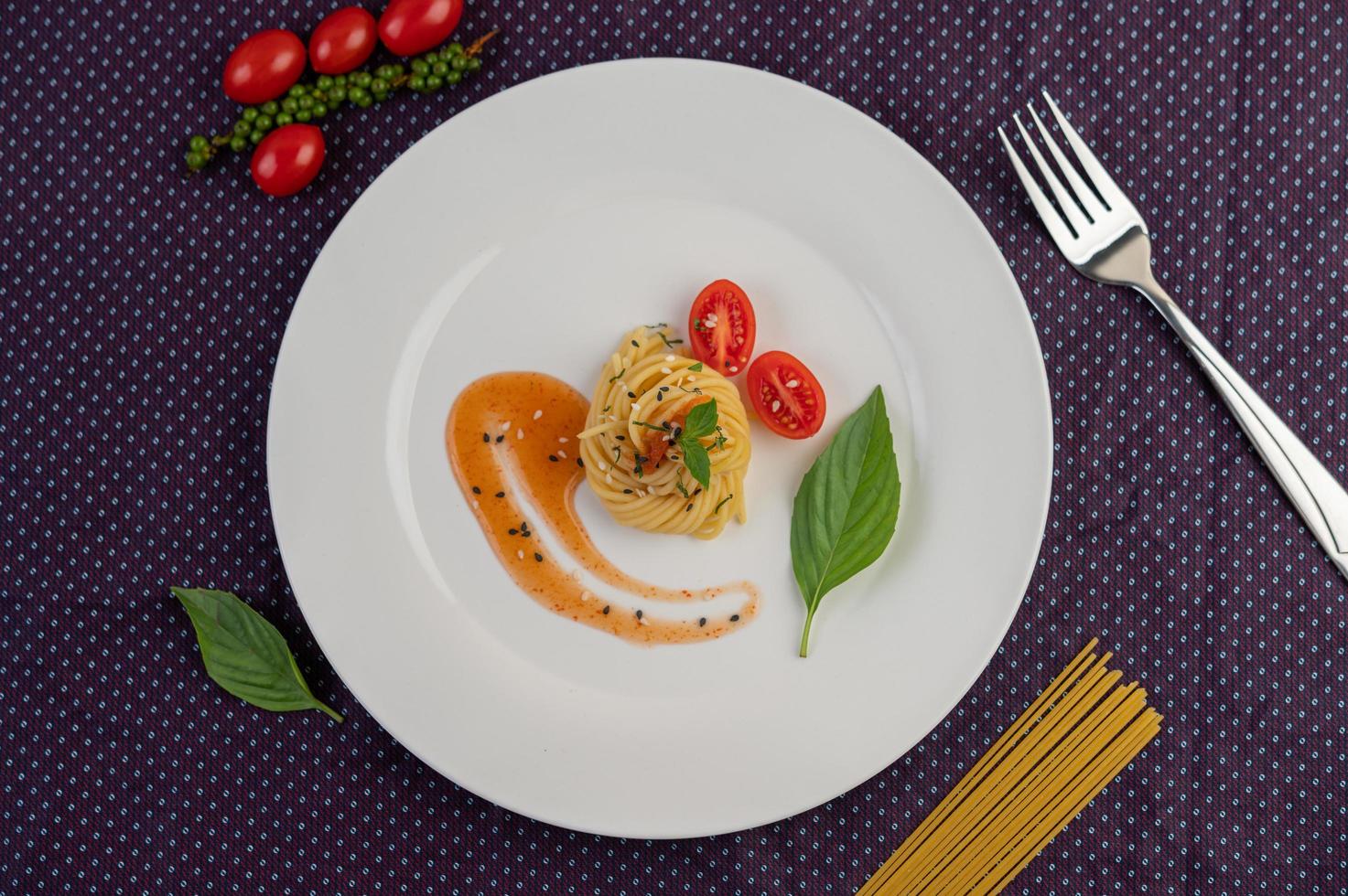 Gourmet-Spaghetti wunderschön auf einem weißen Teller angeordnet foto