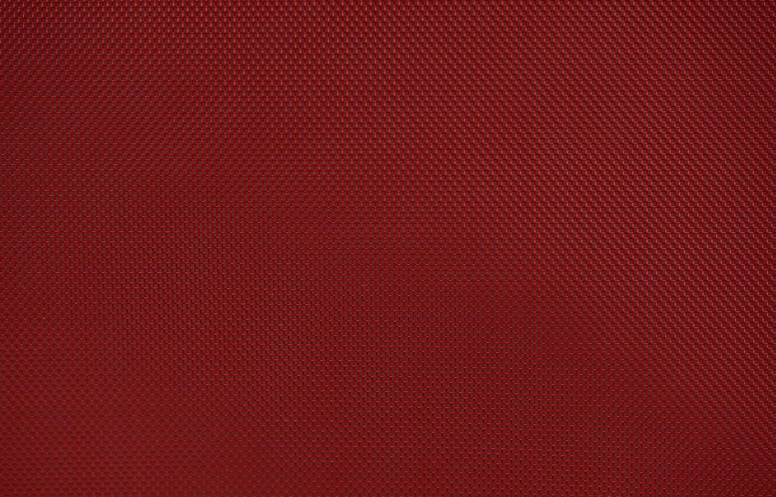 strukturierter Hintergrund des roten Nylongewebes mit sechseckiger Form foto