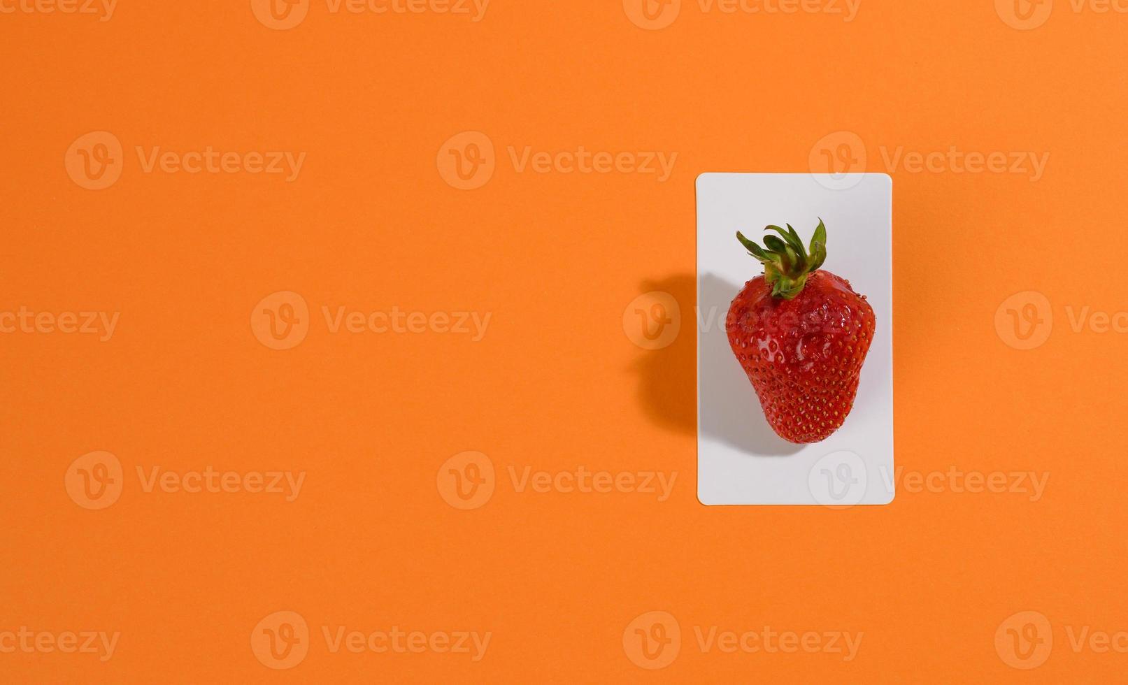 rote reife Erdbeeren auf orangefarbenem Hintergrund foto