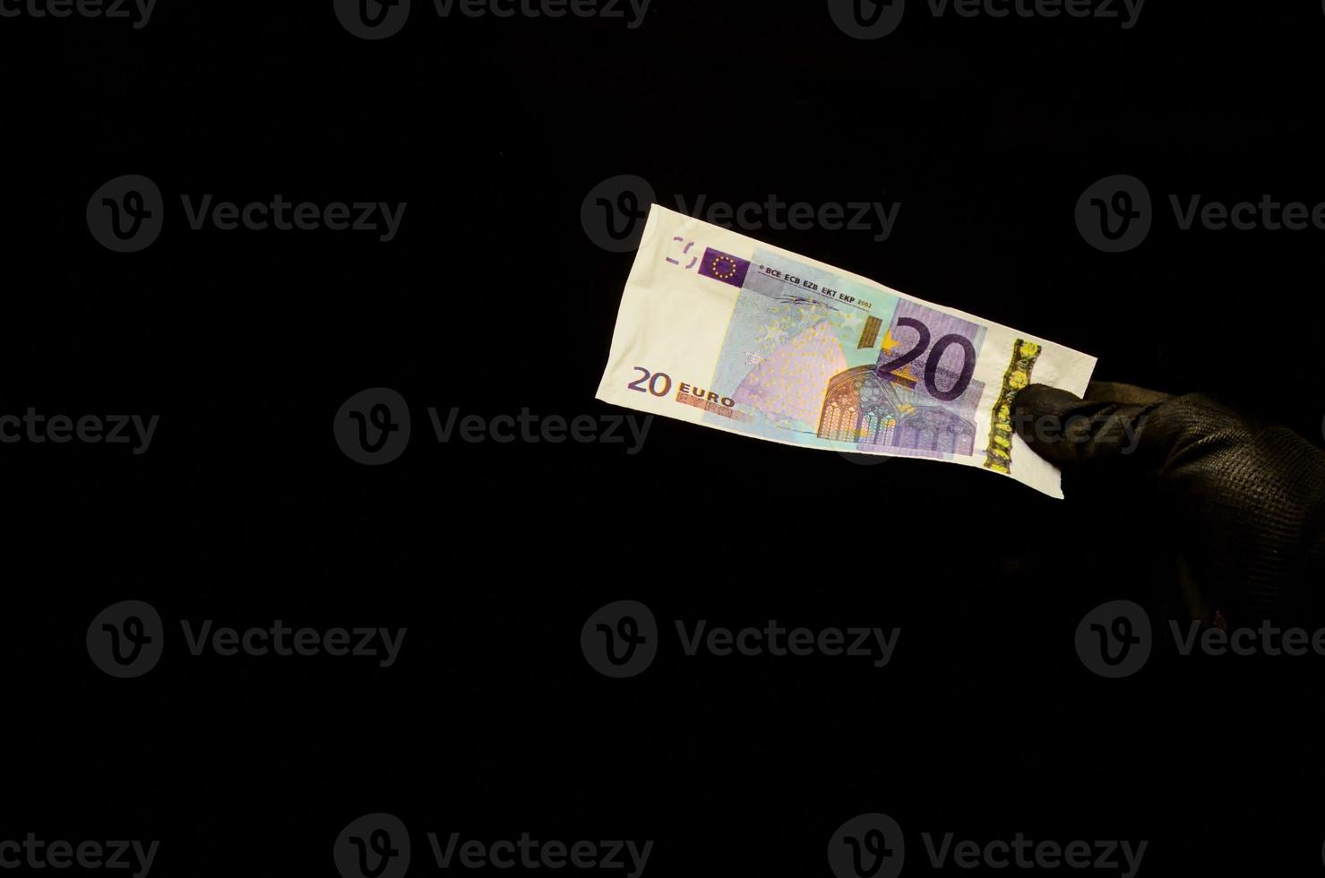 Hand, die eine 20-Euro-Banknote hält foto