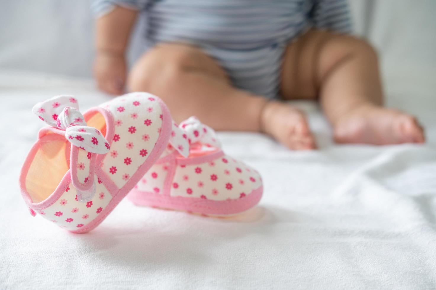 Neugeborene Schuhe auf einer weißen Matratze foto