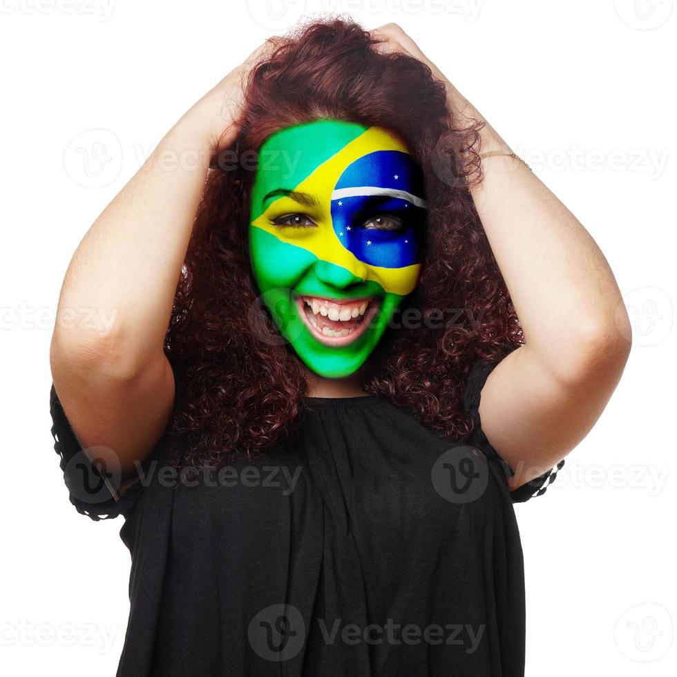 Mädchen mit Gesichtsbemalung der brasilianischen Flagge foto