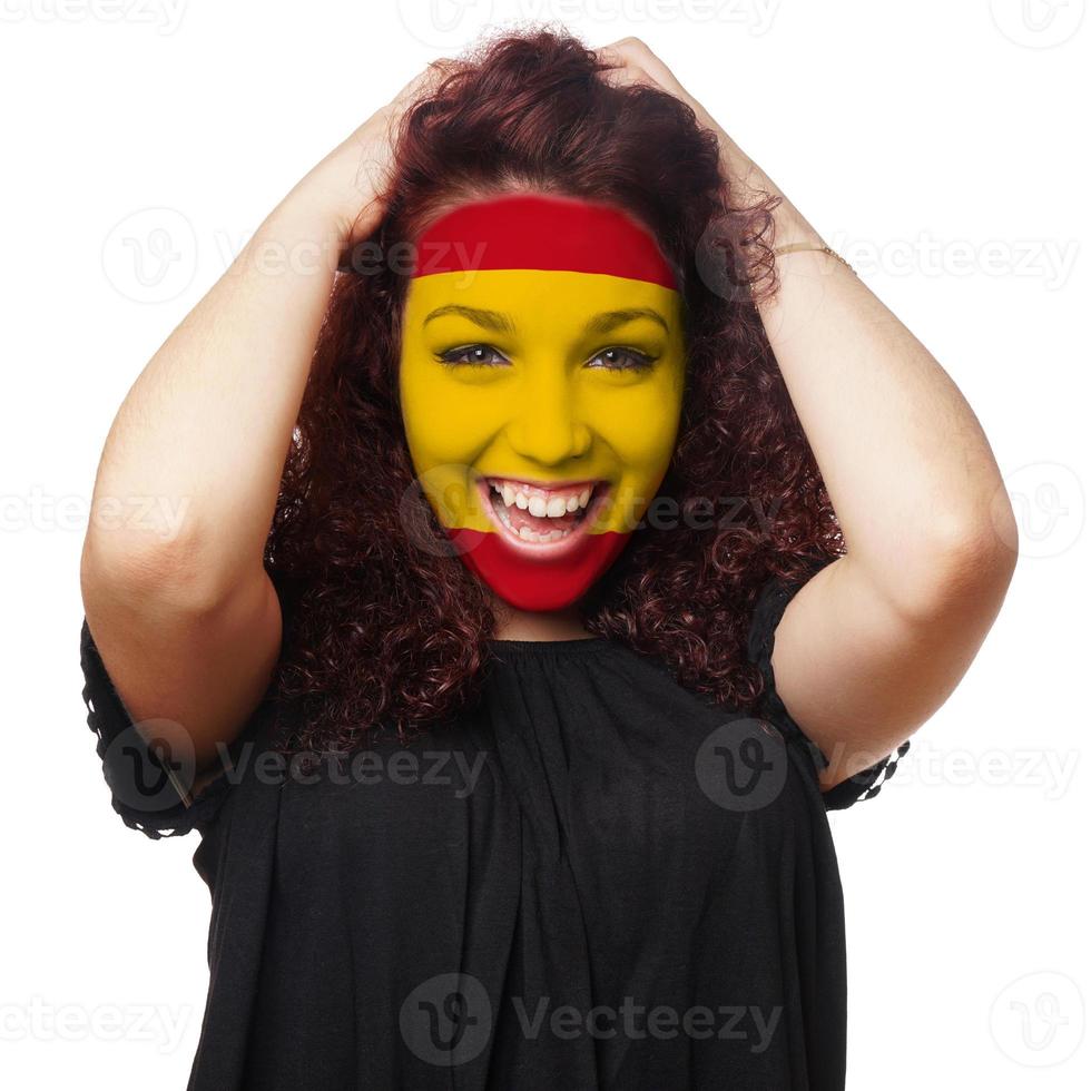 Mädchen mit Gesichtsbemalung der spanischen Flagge foto