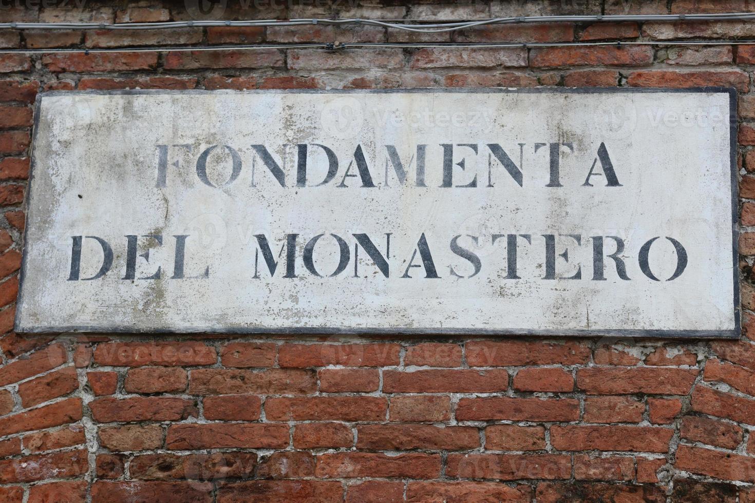 venezianisch Straße Zeichen auf das Kloster Backstein Mauer. Aussicht von das Grundierung del Kloster im Venedig, Italien foto