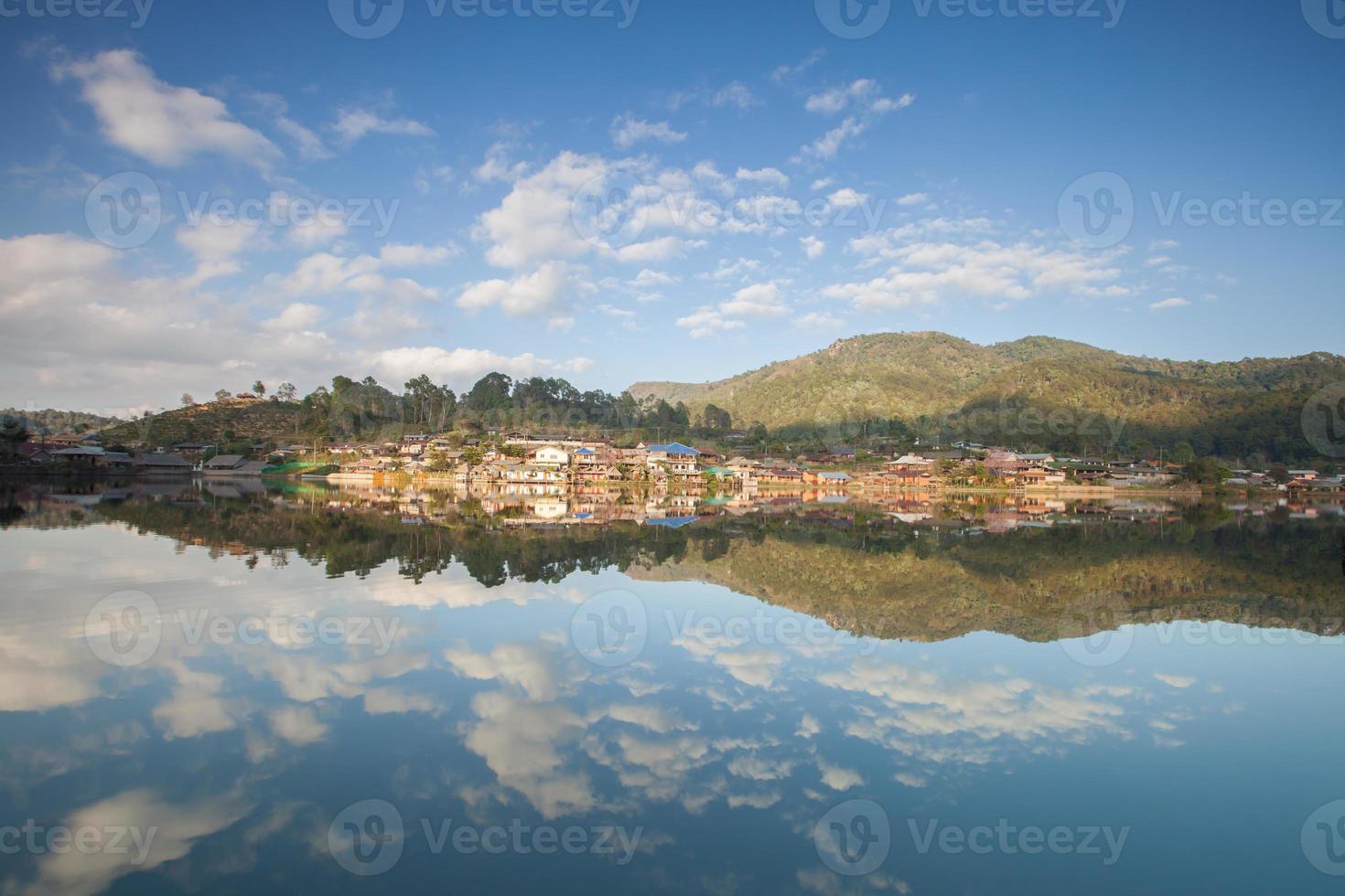 Dorf auf einem Berg im Wasser reflektiert foto