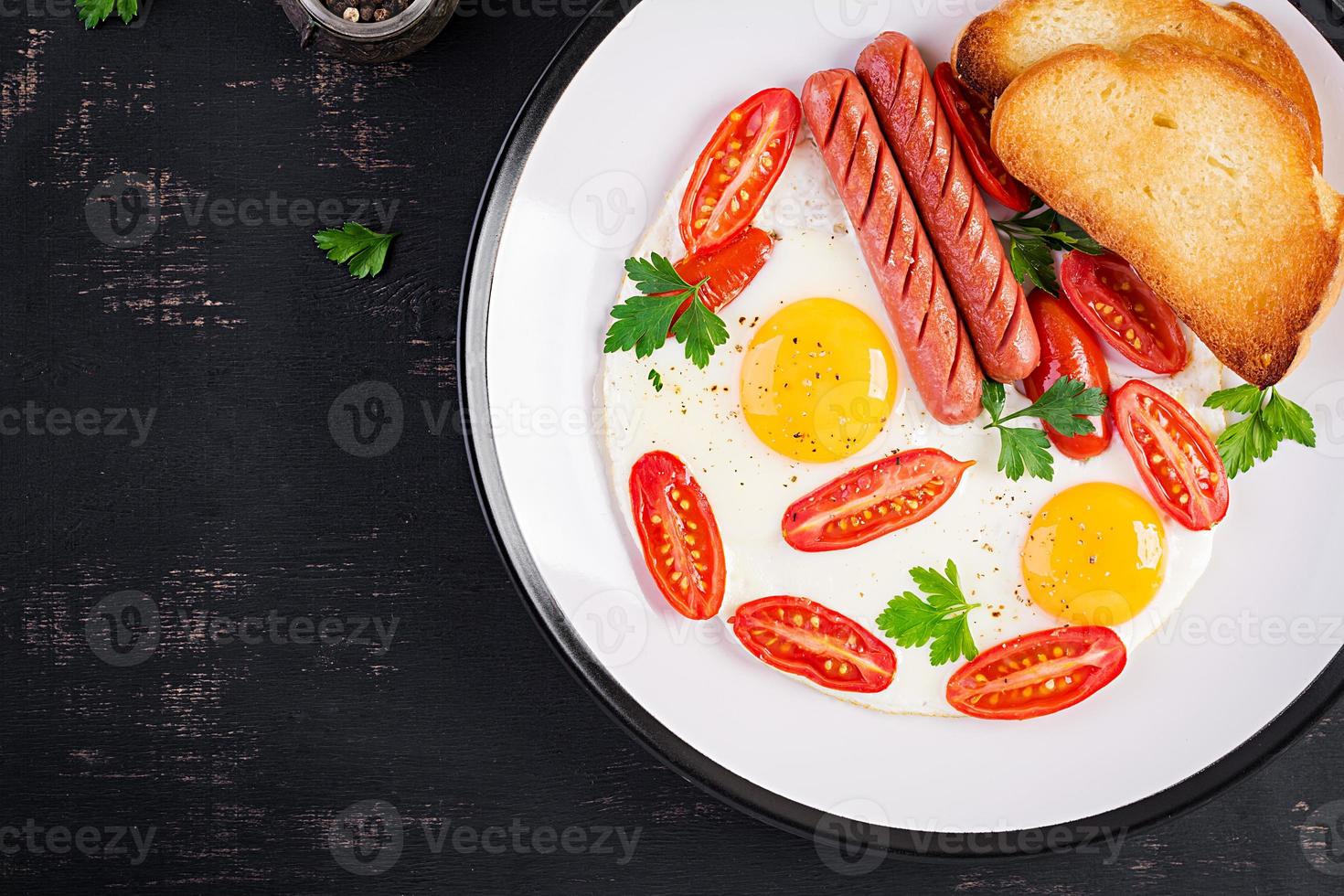 Englisch Frühstück - - gebraten Ei, Tomaten, Wurst, und Toast. oben Sicht, Overhead foto