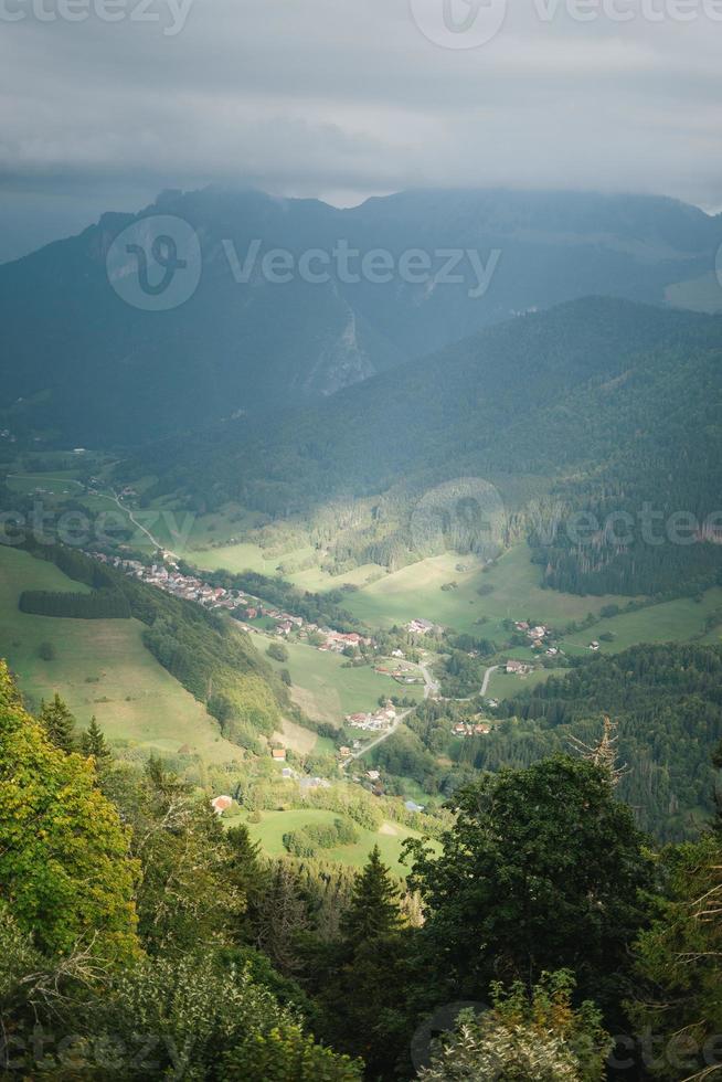 majestätisch Berge im das Alpen bedeckt mit Bäume und Wolken foto