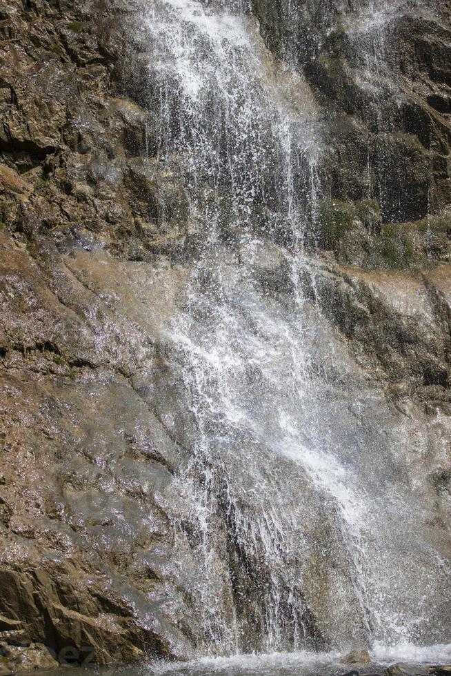 schön Wasserfall im das Berge. Wasser fließt Nieder von das Berge. foto