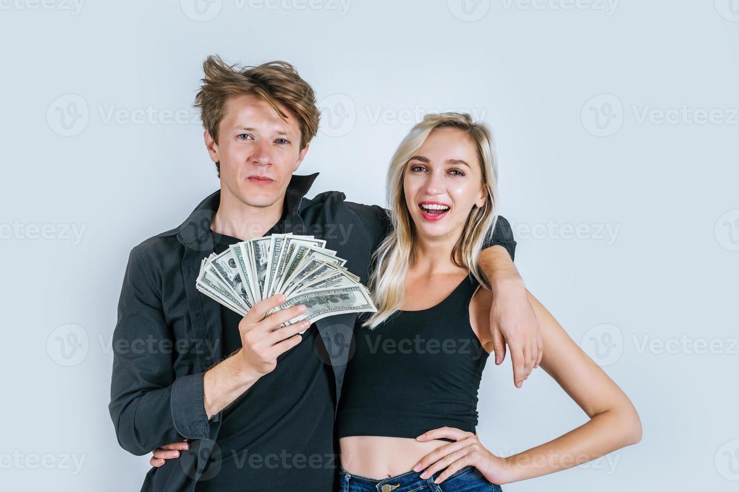 glückliches Paar, das Dollarbanknoten zeigt foto